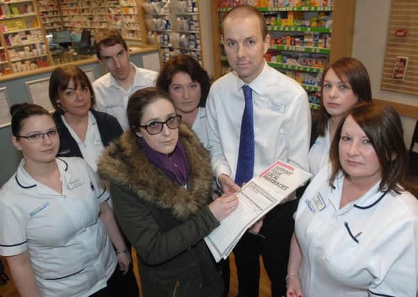 Eleanor Hills signs a petition for James Springell (pharmacy manager) seen here with staff members Magda Kalwak, Tracey Isaac, John Dredge, Vicky Watson, Melissa Benson and Karen Cowgill of Kings Road Pharmacy. (1603081AM)
