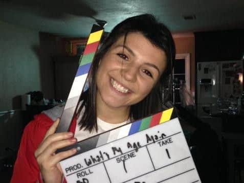 Amy takes a break on-set during filming for a production called What's My Age Again.
