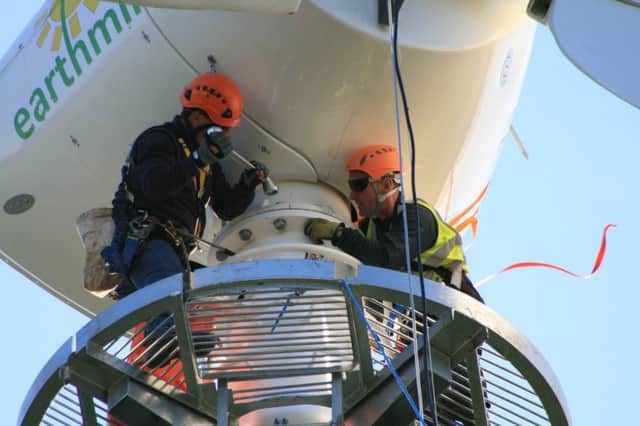 Earthmill turbine maintenance engineers at work. (S)