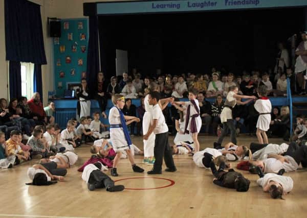 Year 3 and 4 performing their Roman drama.