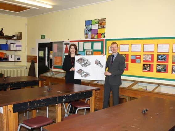 Miss Anne Maguire, Faculty Leader Science and Dr David Robson, Assistant Headteacher and Physics Teacher hold plans for the new facility in one of the current science labs.