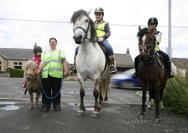 Joann Pollock complaining that drivers have no idea how to act when passing horses on the road. Lucy Corroon (7) on Halle; Lauren Hamilton on Merlin; Sophie Corroon (10) on Coco.