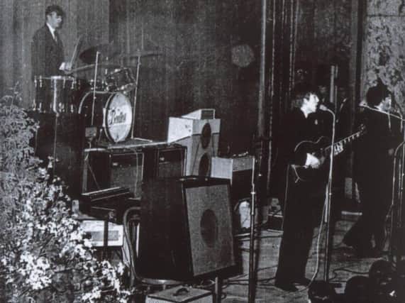 The Beatles at Harrogate's Royal Hall in 1963 with George Harrison at the microphone taking his turn on lead vocals while Paul McCartney plays bass and Ringo Starr sits on drums behind him. (Picture courtesy of George McCormick)