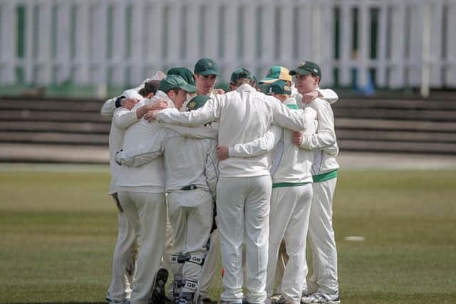The Harrogate players huddle before fielding (Photo: Caught Light Photography)