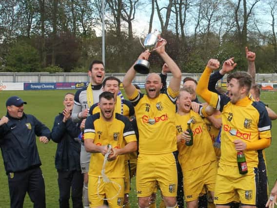 Jimmy Beadle lifts the NCEL title (Photo: Keith Handley)