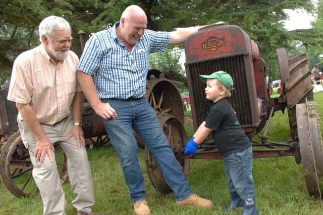 NARG 1606112AM6 Tractor Fest at Newby Hall. 3 years od Sam Kidd with his dad Dave Kidd and grandfather John Clarke.(160112AM6)