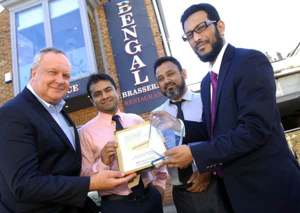 NADV 1606211AM1 Curry House of the Year.Account Executive for Johnston Press John Rudzik presents Shamim Akhter (co-owner)
, Shayasta Miah (co-owner) and Malik Dobir (owner) of Bengal Brasserie with their 1st prize award., (1606211AM1).