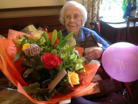 Bessie Brooke with her 100th birthday bouquet of flowers.