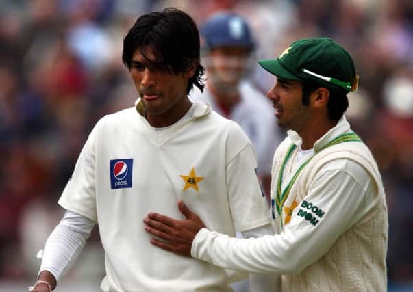 Pakistan's Mohammad Amir being advised by his captain Salman Butt (right) back in 2010.