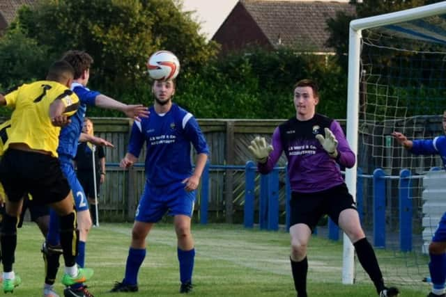 Warren Burrell's powers a header toward goal (Photo: Craig Hurle)