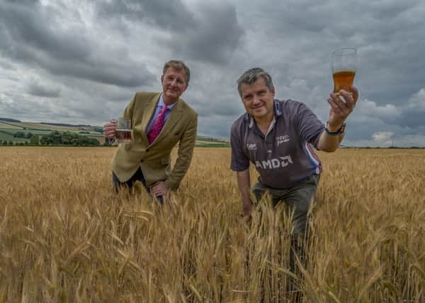 Simon Cockerill (left) with Mark Lockwood, from Westfield House Farm, Wold Newton, Driffield, in a field of barley