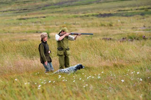 Gun dog handler Fiona Kirk with her English Setter, Zeus and Anthony Dowson  28, Moorland Beat Keeper for the Thimbleby estate, stalking game on the moor.