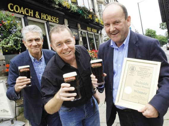 Mike Berriman and Vincent Staunton of Daleside Brewery receiving the award for Beer of The Year from Nigel Croft, branch secretary of Barnsley CAMRA, outside the Coach & Horses in Harrogate.