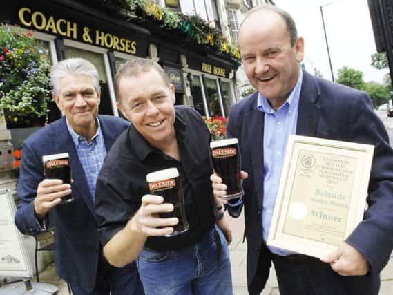Mike Berriman and  Vincent Staunton  of Daleside Brewery receiving the award for  Beer of The Year from Nigel Croft, branch secretary of Barnsley CAMRA, outside the Coach & Horses in Harrogate.