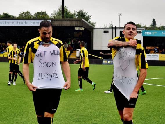 Harrogate Town players Joe Leesley and Luke Shiels share messages of support for injured Lloyd Kerry after scoring. Kerry fractured his cheekbone in the win over FC Halifax Town on a Bank Holiday Monday (Photo: Craig Hurle)