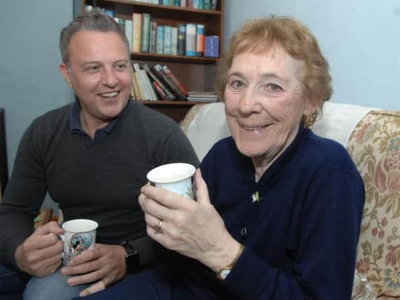 Supporting Older People volunteer Jason Daniel has a chat and a cup of tea with 79-year-old Anne Martin