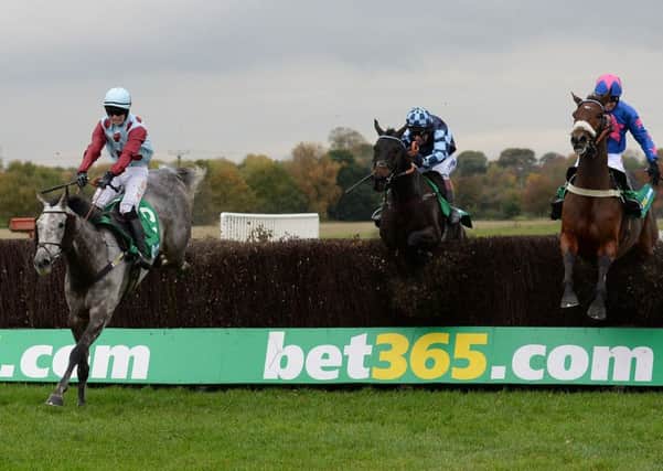 Irish Cavalier ridden by Jonathan Moore (left) clears the last fence to win the bet365 Charlie Hall Steeple Chase during day two of the bet365 Charlie Hall Meeting at Wetherby Racecourse. (Photo: PA)