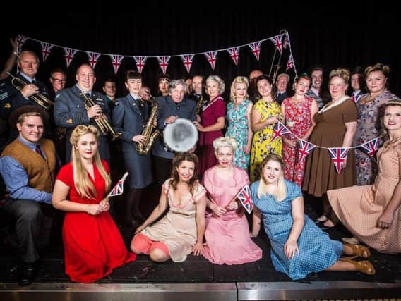 Christine Littlewood stands centre stage amongst the Echo 42 big band and the rest of the cast of In the Mood ready for the HOPS production.
