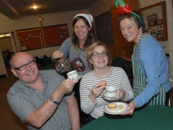 Attendees of Dementia Forward's wellbeing cafe share memories over a mince pie.
