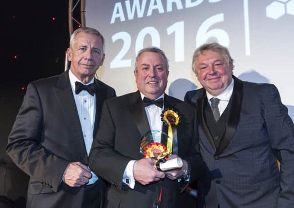 Brian Moses of The Book Stall at Harrogate railway station collects his Newsagent of the Year Award at the NFRN Awards 2016 in London from (left) Jim Fox, associate director of public affairs for Coca Cola European Partners which sponsored this category on the left and (right) Nick Ferrari, radio presenter, who hosted the awards.