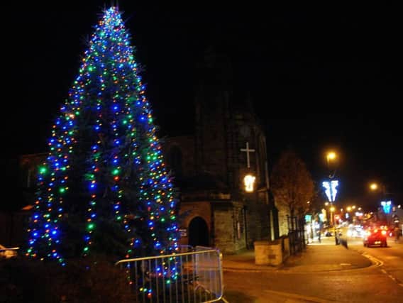 The Christmas tree outside St Andrew's Church, where crowds gathered to watch the Rev Philip Carman push the button to switch the lights on.