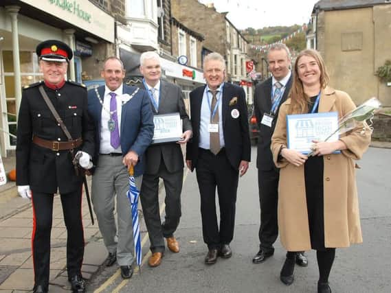 A smiling leader of Pateley Bridge's successful bid, Keith Tordoff, centre with judges from the Great British High Street competition.