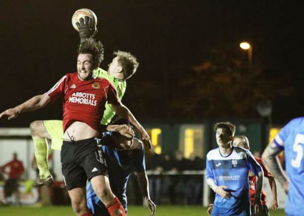 Knaresborough Town's Colin Heath is beaten to the ball by Rossington Main's goalkeeper. Picture: Craig Dinsdale