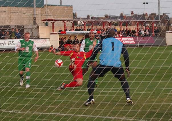 Sam Denton, pictured in action for Scarborough Athletic (red kit) has signed for Harrogate Railway