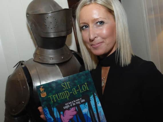 Harrogate children's author author J. Knight Conry with the cover of her book Sir Trump-a-Lot.