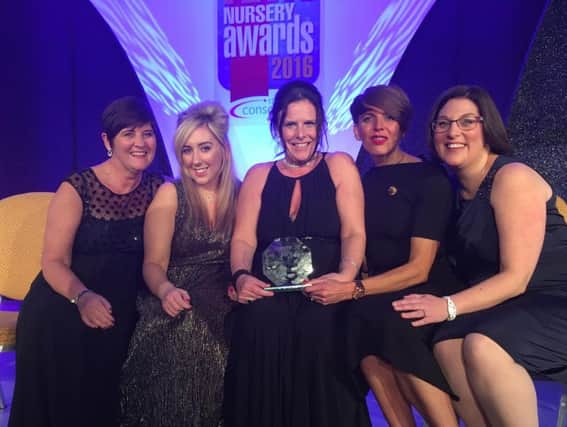 Sunbeams managing director Kate Plews, left, with members of the team showing off their award.