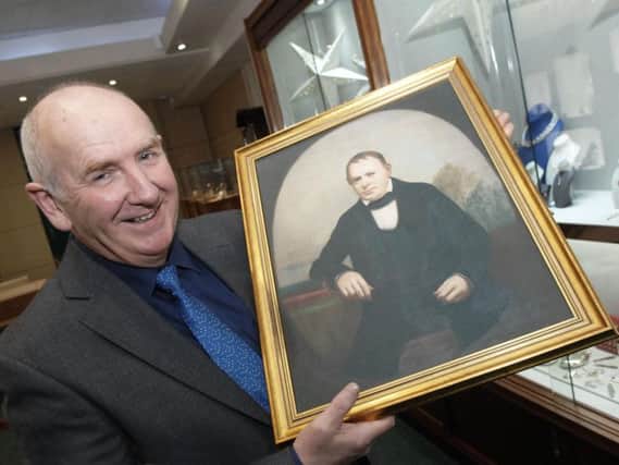 Fattorinis owner Anthony Tindall in the Harrogate jewellers with a portait of the shops founder in the 19th century, Antonio Fattorini.  (1612192AM2)