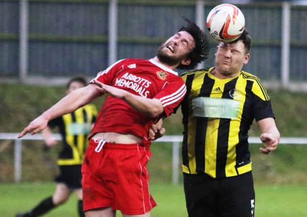 Colin Heath, score of Knaresborough Town's first goal, challenges a Nostell man for a high ball. Picture: Craig Dinsdale
