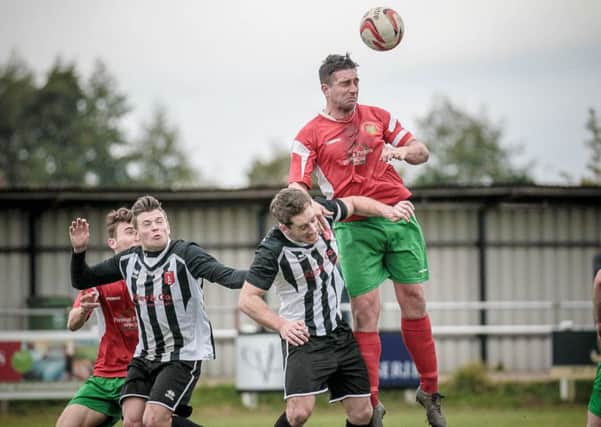 Railway player-boss Paul Beesley wins a header during his side's triumph over Clipstone in October. Picture: Caught Light Photography