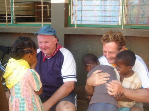 Coun Martin and fellow TASC Trustee Pat OBrien meeting children in Madagascar.