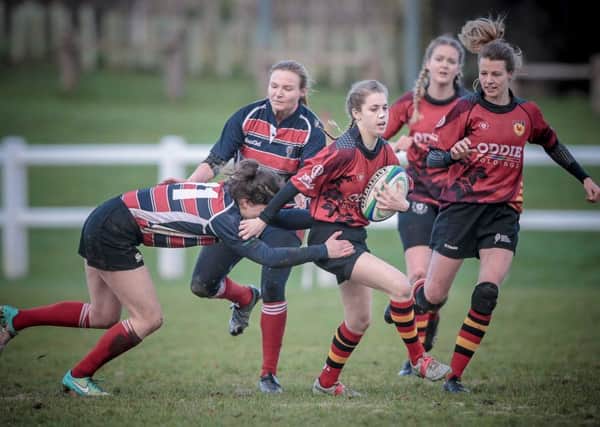 A Harrogate RUFC Ladies player tries to escape the attentions of a Morpeth defender during Sundays clash at Rudding Park. Picture: Caught Light Photography