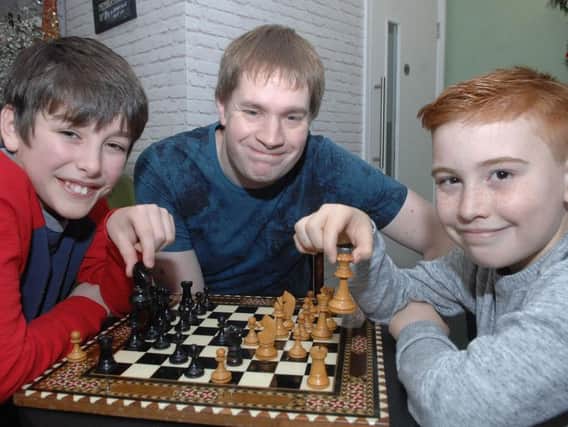 Harrogate Youth Chess Club. Young players Zach Washbrook (11) and Max Collins (11) with founder of The Harrogate Youth Chess Club Andrew Zigmond. (1701096AM1)