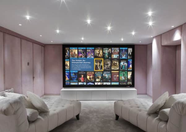 Cinema room with upholstered walls and day beds