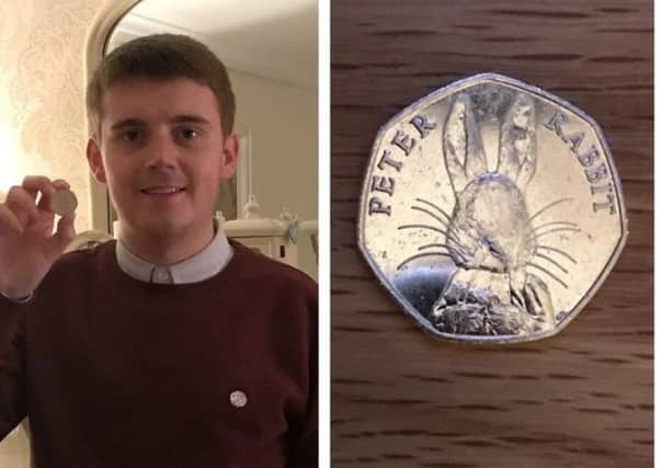 Caolán McGinley, pictured with the coin he found.
