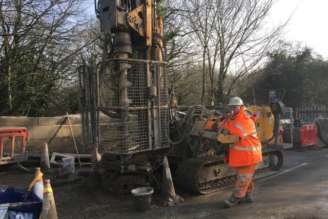 A highways engineer drills into the pier ready for a concrete pile to be fitted in.