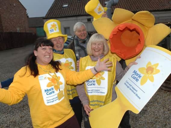 Marie Curie Community Fundraiser for North Yorkshire Gemma Hewitt with volunteers Jane Sampson,  Paul Warrington, Liz Tite and Ian Sampson as the daffodil.(1702133AM1).