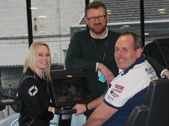 Councillor Stanley Lumley is put through his paces on the new high tech equipment at Brimhams gym at Nidderdale Leisure Centre by fitness instructor Kate Roberts and Sport and Leisure Operations Manager Ben Cutting.