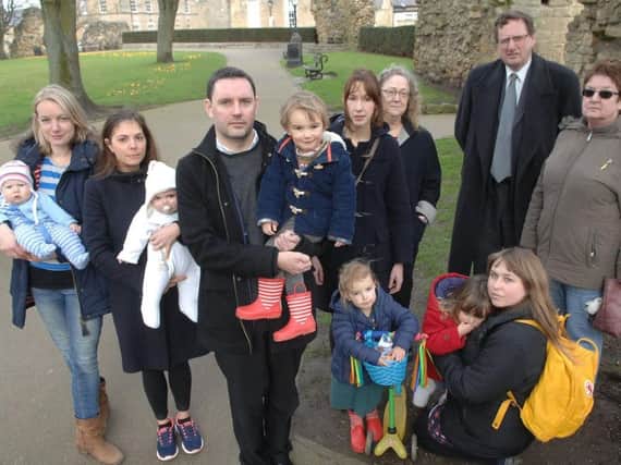 Councillor James Monaghan with his son Rowan (2) and other concerned residents.