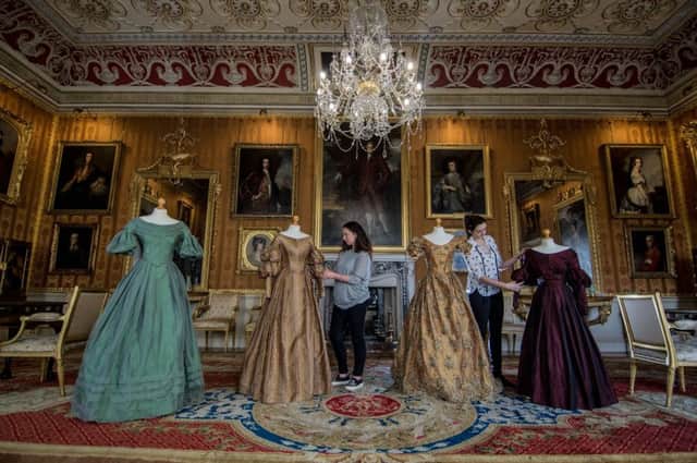 Pictured Lucy Allen and Alexis Guntrip arranging a collection of the dresses worn in the series. PIC: James Hardisty