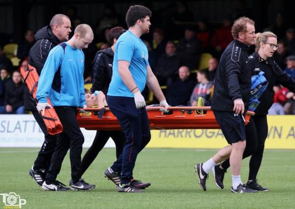 Harrogate Town midfielder Lloyd Kerry leaves the pitch on a stretcher during Saturday's clash with Chorley. Picture: Town Pix