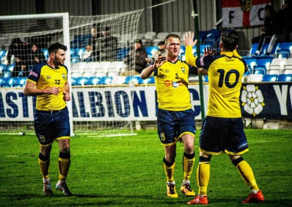 Tadcaster Albion's three goalscorers on the night, Carl Stewart, Gregg Anderson and Josh Greening celebrate after Anderson found the back of the Trafford net. Picture: Matthew Appleby