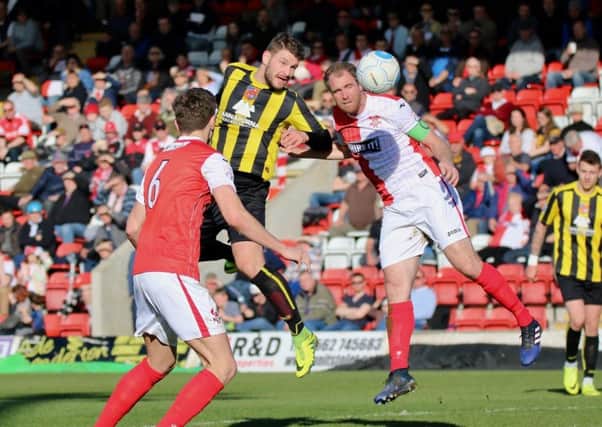 Simon Ainge climbs highest to win a header during Harrogate Town's defeat at Kidderminster. Picture: Town Pix