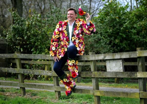 Show director Nick Smith dons a coat of many flowers, to launch national Wear a Flower day.
Picture Jonathan Gawthorpe