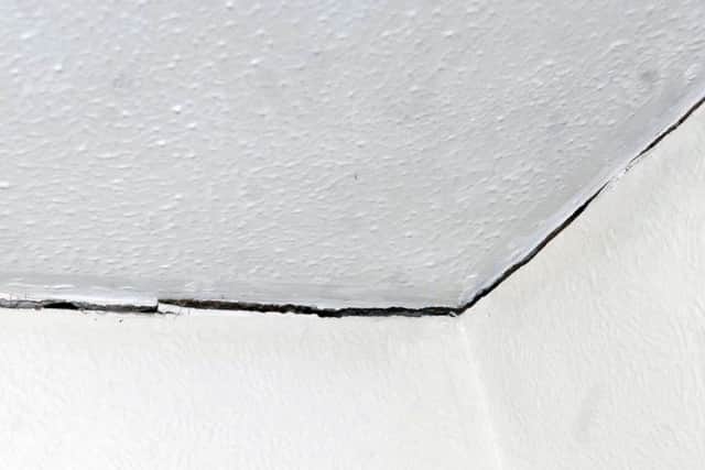 The cracks are centimetres wide in places and go all around the edges of the ceilings and walls in Mr Johnson's and Mrs Richardson's homes. Picture: Adrian Murray