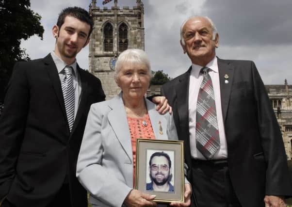 Pictured before the 2012 memorial service to mark the 20th anniversary of the murder of Special Constable Glenn Goodman are his son Thomas and parents Margaret and Brian.  (120614M2a)