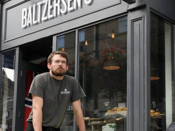 Love our Indies - Paul Rawlinson, owner of  Baltzersens outside his independent cafe  in Harrogate.